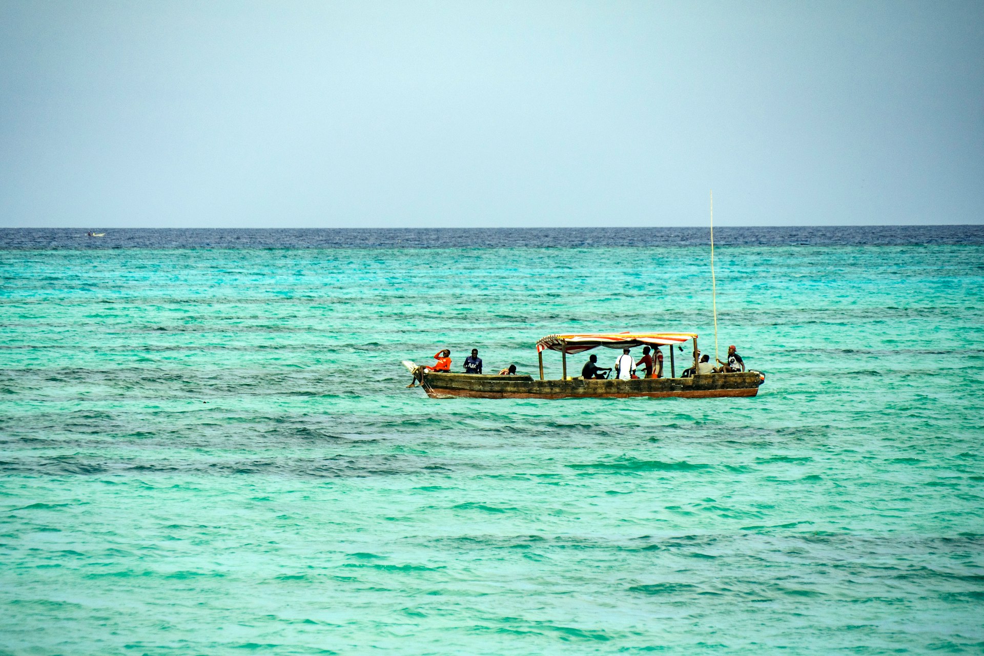 group of people riding on the boat surrounded by body of water